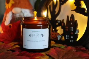 Handmade Scented Candles made with Soy Wax and Wooden Wicks, this one is in a glass jar, with the label that says 'Apple Pie'