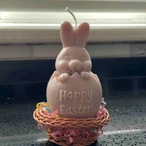 candle in the shape of a bunny coming out of an Easter egg