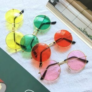 4 similar sunglasses, with different coloured lenses, the colours of the lenses are yellow, green, red and pink