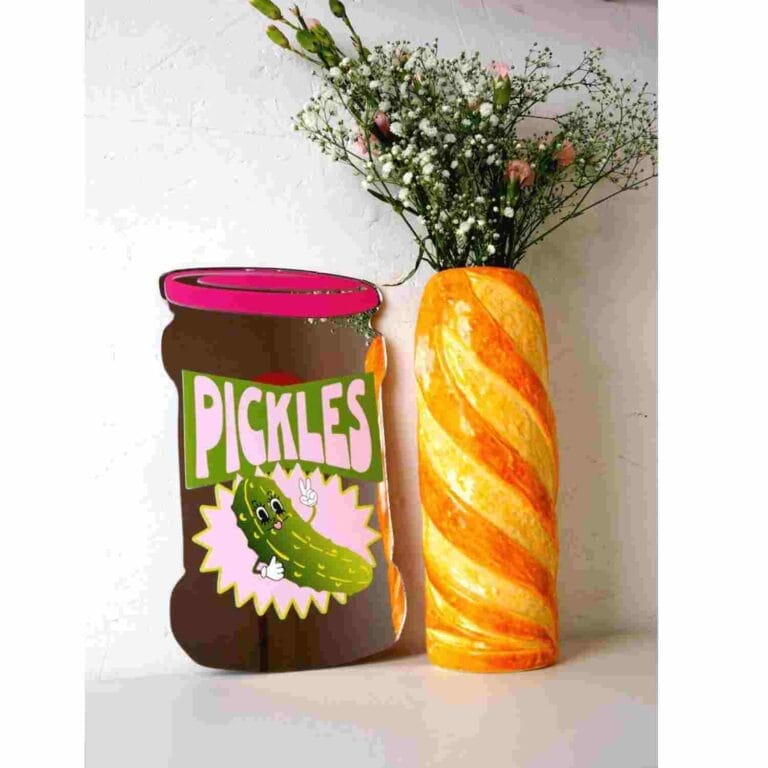 Perfect for the pickle addicts! Featuring a gerkin smiling back at you, this pickle jar-shaped mirror is sure to add a playful &fun touch to any kitchen.