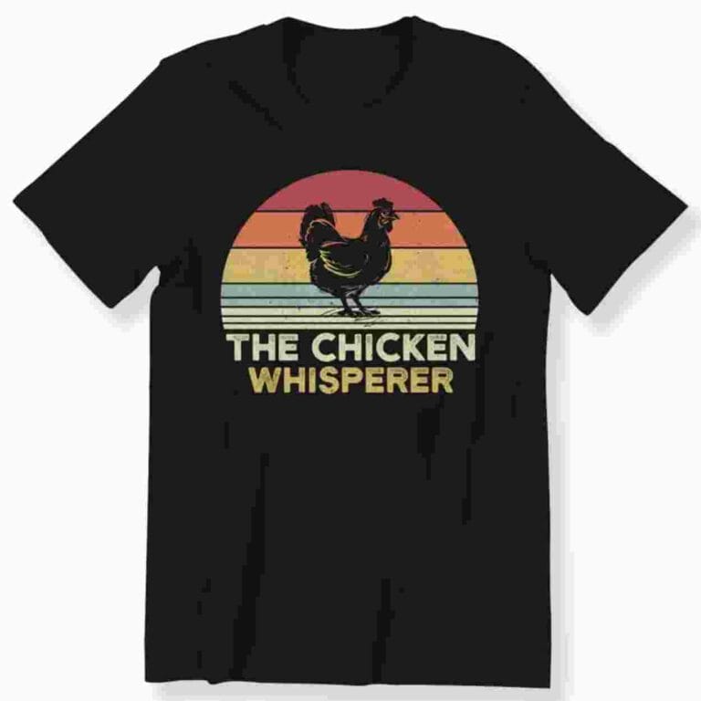 A black tshirt with a silohuette of a Chicken and the words 'The Chicken Whisperer'