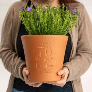 Custom ceramic plant pot with engraved name – thoughtful gardening gift for 70-year-old woman.